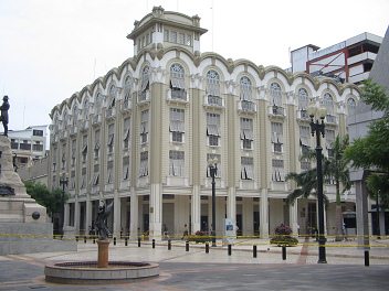 Centro de Guayaquil, un edificio de la
                          administraci�n municipal en blanco, un viejo
                          edificio bello, y antes hay una fuente de
                          �ngel, a la izquierda el monumento Sucre