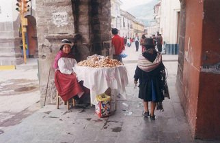 Plaza de Armas: A woman ind�gena selling
                        pastry on a table