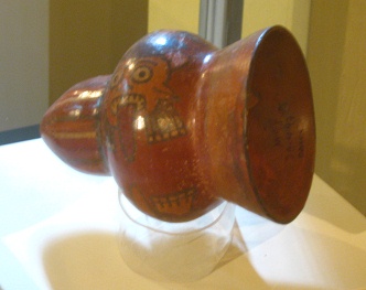 Little drum body of Nazca
                                    culture 03, close-up showing a face
                                    with a long tongue