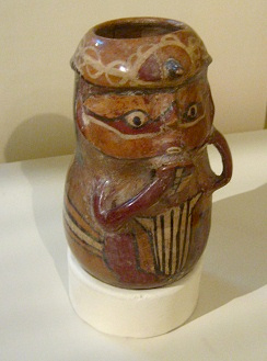 Vessel in form of a pan flute
                                    player, close-up