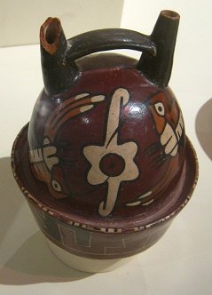 Ceramic bottle of Nazca culture
                                  with hummingbirds (01) flying around a
                                  flower, close-up 01